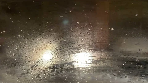Foggy car window in snowfall winter day with traffic light and pedestrian  Video stock 124738323