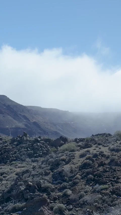 Foggy cloud layer passing over a volcanic landscape Vídeos de archivo 329865309