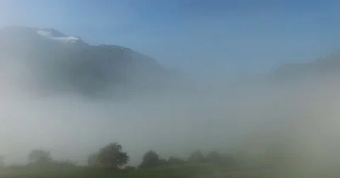 Foggy Clouds Between Mountains 2 Stock Footage 82269539