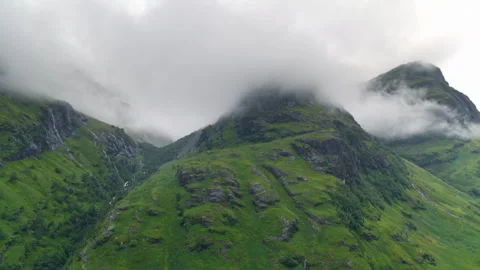 Foggy clouds moving over green mountain peaks Video stock 336796006