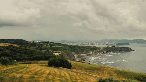 Foggy cloudy day dramatic clouds seaside timelap with cliffs and green grass Stock Footage 92576093
