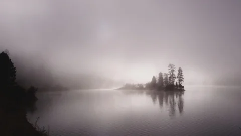 Foggy dramatic scene looking across Swan Lake in Montana Stock Footage 127466837