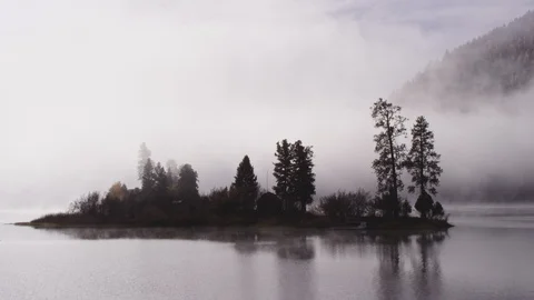 Foggy dramatic scene looking across Swan Lake in Montana Stock Footage 127468011