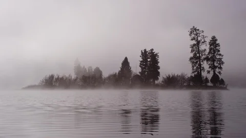 Foggy dramatic scene looking across Swan Lake in Montana Stock Footage 127468327
