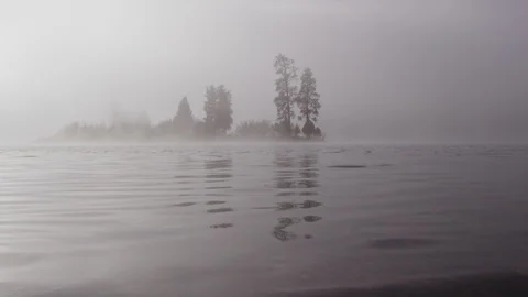 Foggy dramatic scene looking across Swan Lake in Montana Stock Footage 127468399