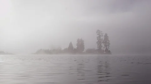 Foggy dramatic scene looking across Swan Lake in Montana Stock Footage 127468461