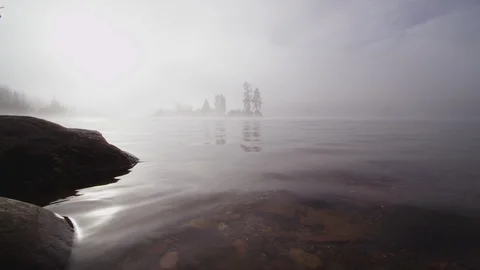 Foggy dramatic scene looking across Swan Lake in Montana Stock Footage 127468463