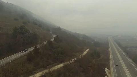 Foggy Drone flight over the mountain's streets Stock Footage 71567978