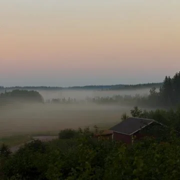Foggy fields on sundown Stock Photos