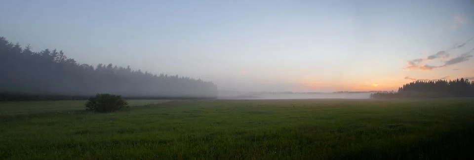 Foggy fields on sundown Stock Photos