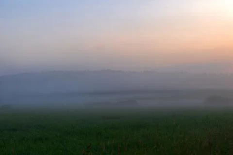 Foggy fields on sundown Stock Photos