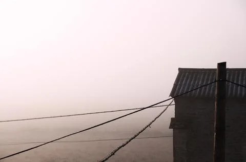 Foggy landscape with rustic building Stock-Fotos