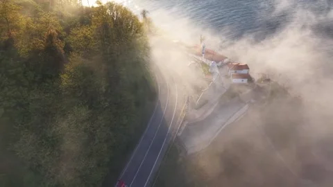 Foggy Lighthouse Road at Sunset with Large Vehicle Entering the Mist Stock-Footage 339321834