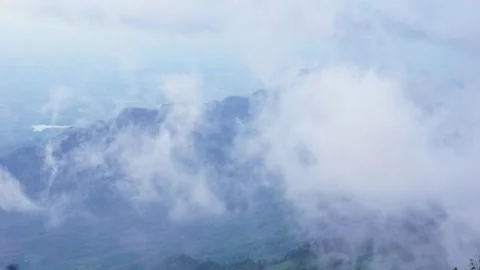 A foggy mountain landscape with mist enveloping the peaks, creating a seren.. Stock Footage 278239129