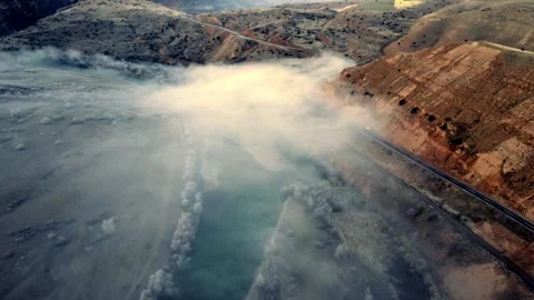 A foggy mountain range with a river running through it Stock Footage 331356880