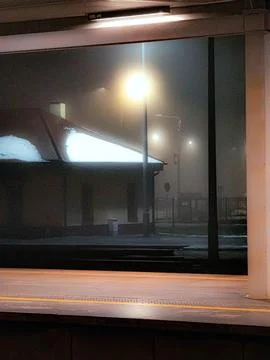 Foggy night at empty train platform Stock Photos