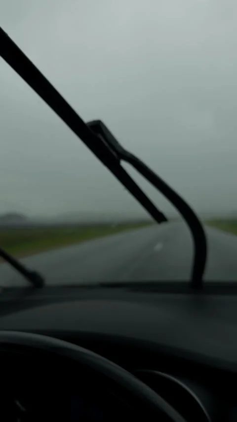 Foggy rainy road view through car windshield with blurred horizon and dashboard Stock Footage 345763249