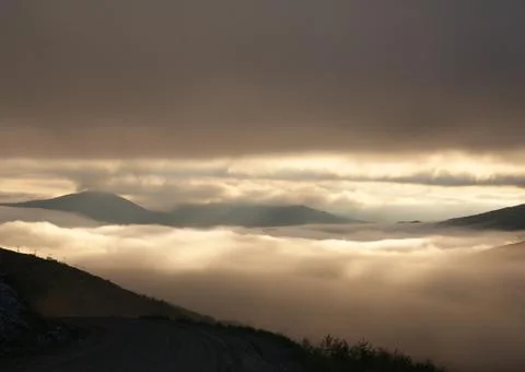 Foggy sunset in the mountains Stock Photos