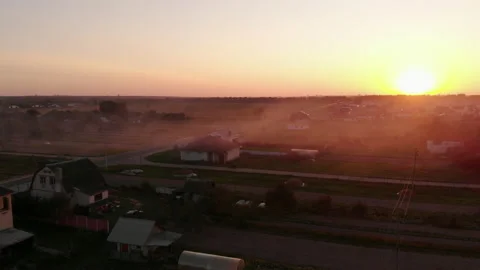 Foggy sunset over plain and road near rural village with houses Stock Footage 169481918