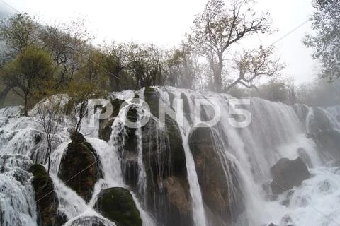 Foggy waterfall Stock Photos
