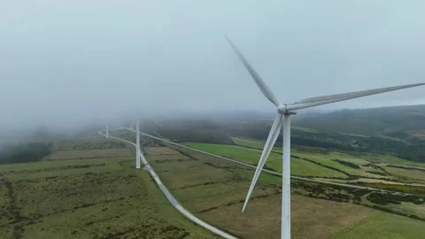 Foggy wind turbines generating renewable energy in Farrapa, Spain Stock Footage 345670911