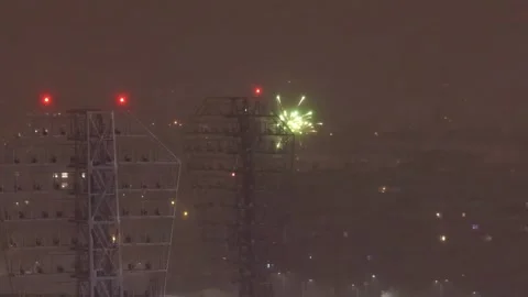 Foggy winter night skyline with distant New Year fireworks flashing behind Stock Footage 326369837