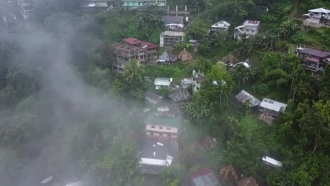 Fogs cover houses built on the side of the mountain Stock Footage 224644658