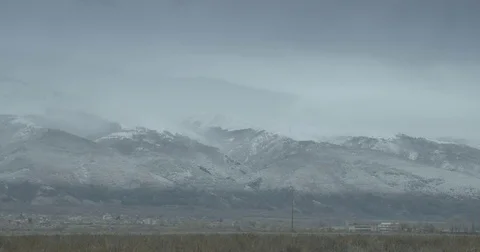 Fogs rise above snow-covered mountains-timelapse Stock Footage 83194430