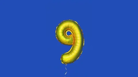 Foil balloon with number 9 moving across blue screen Stock Footage 315516052