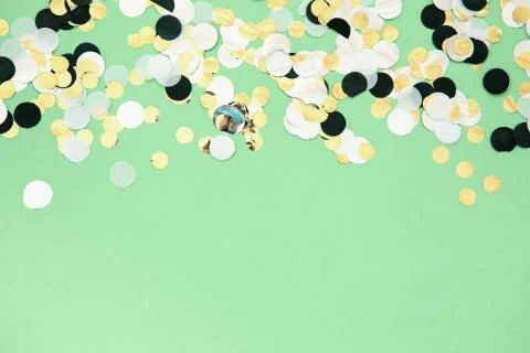 Foil confetti sparse on trendy mint colored background Stock Photos