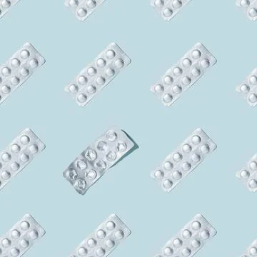 Foil packaging of pills seamless pattern on a blue background. Photos