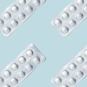 Foil packaging of pills seamless pattern on a blue background. Stock Photos