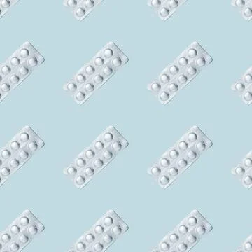 Foil packaging of pills seamless pattern on a blue background. Stock Photos