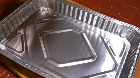 Foil-shaped pork knuckle being prepared for baking Stock Footage 249599283