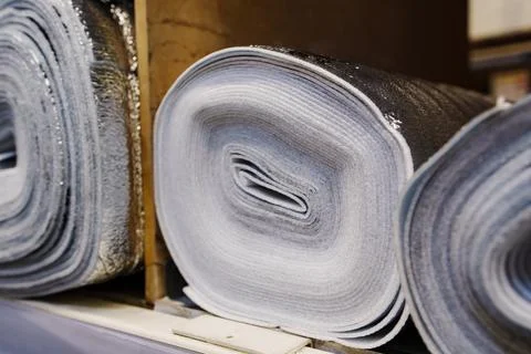 Foiled polyethylene insulation rolls on shelf Stock Photos