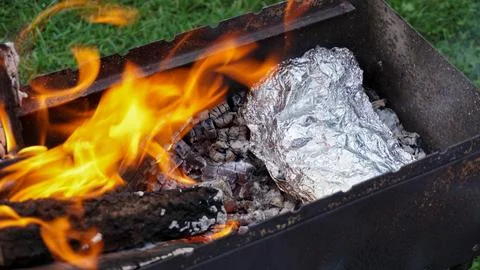 Foiled vegetables or meat cooked in charcoal Stock Photos