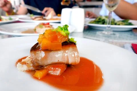 Fois gras in mango mixed fruit sauce served on white plate dish in restaurant Stock Photos