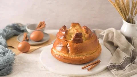 Folar cake for Easter celebration on a marble serving board Stock Photos