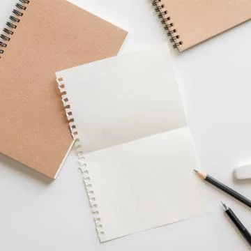 Fold graph paper with spiral notebook, pencil and eraser on white background. 写真素材