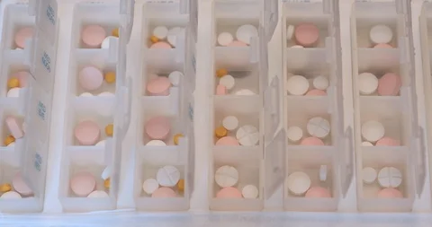 Fold small yellow tablets into boxes for daily use with tweezers Stock Footage 102626724