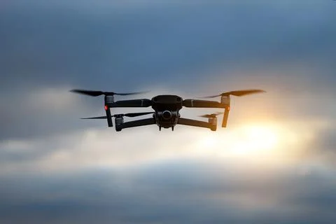 Foldable drone copter flying with a digital camera in mountains. Stock Photos