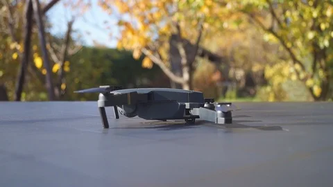 Foldable drone take off from the table, left view Stock Footage 97727532