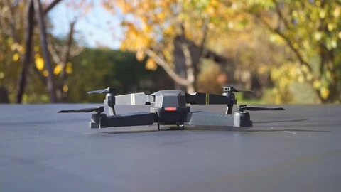 Foldable drone take off from the table, rear view Stock Footage 97727489