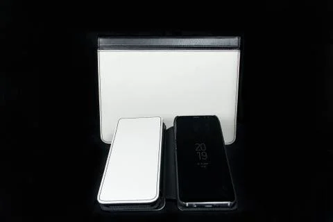 Foldable Phone and tablet Case white and black leather blank on black backgro Stock Photos