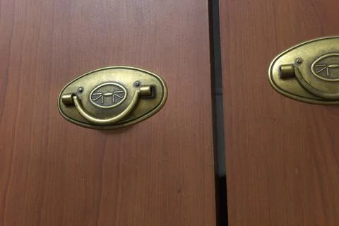 Foldable pull handle; artificially aged brass folding knob, attached to the.. Stock Photos