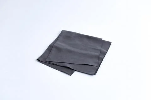 Folded black microfiber cleaning cloth for lenses isolated on white backgroun Stock Photos