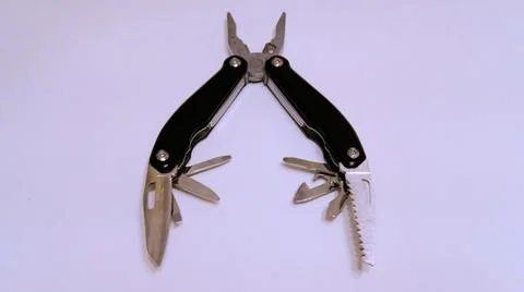 Folded black multitool on a white background Stock Photos