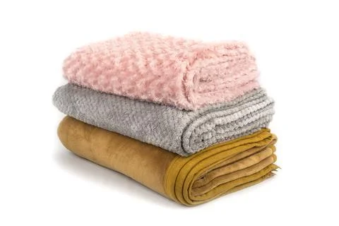 Folded blankets on a white background Stock Photos