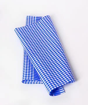 Folded blue and white checkered napkin Foto stock
