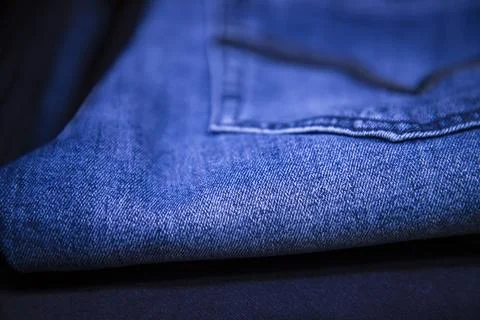 Folded blue jeans pant pattern texture. Selective Focus Stock Photos